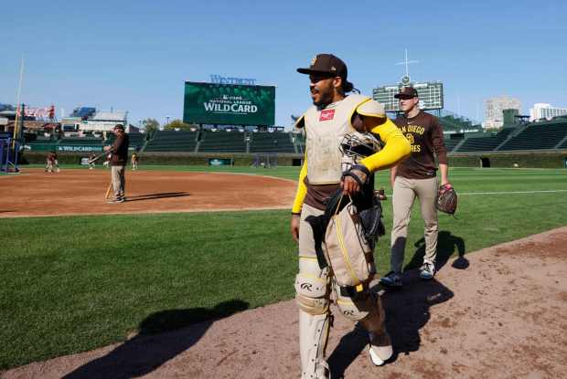 Luis Campusano #15 of the San Diego Padres and Nick Pivetta #27 walk to the dugout during a practice before the Wildcard series against the Chicago Cubs at Wrigley Field on Sept. 29, 2025 in Chicago, Illinois. (Photo by K.C. Alfred / The San Diego Union-Tribune)