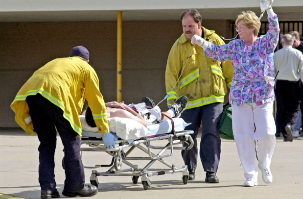 Paramedics evacuate victim, labeled #4, from Santee High School after student, Andy Williams shot 9 people, killing two.(Nancee E. Lewis / UT File)