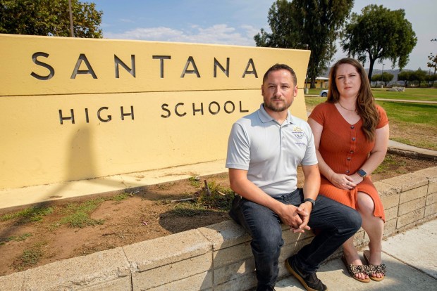 Phil Ortiz was a 16-year-old sophomore at Santana High School when a shooter opened fire as Phil headed to class in March 2001. He and a friend Kristen Dane a former student started a petition in opposition to any release on parole for the school shooter, Andy Williams. The parole hearing is next week. They pose for a photo outside the Santana High School campus in Santee on Friday, Sept. 6, 2024 in San Diego, California. (Alejandro Tamayo / The San Diego Union-Tribune)