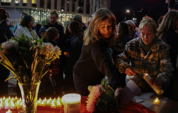 Mourners pay tribute during a candlelight vigil at the VA Hospital at UCSD in University City on Thursday, January 29, 2026.  The vigil was in honor of slain nurse Alex Pretti who was killed by ICE agents in Minneapolis. (Sandy Huffaker / For The San Diego Union-Tribune)