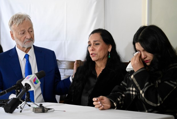 Maria Esther Enriquez, widow of Carlos Enriquez, speaks as daughter Aleyna Enriquez, right, and attorney Gene Iredale, look on at a news conference Wednesday in San Diego. (Denis Poroy / For The San Diego Union-Tribune)