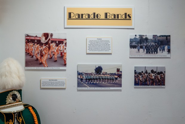 Old photos from the Lemon Grove Junior High Band along with band memorabilia are displayed at the "Old Time Days" exhibit at the Lemon Grove Historical Society's Parsonage Museum on Dec. 6, 2025. "The band hat was likely worn around 1990-2000." (Ariana Drehsler / For The San Diego Union-Tribune)