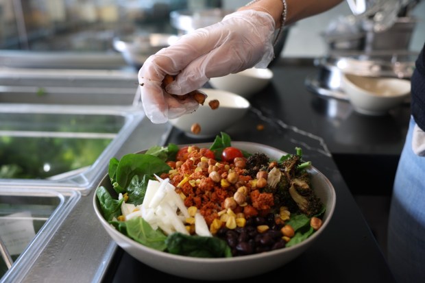 Roasted corn is scattered on a Sprout and Grain Salad. (Hayne Palmour IV / For The San Diego Union-Tribune)