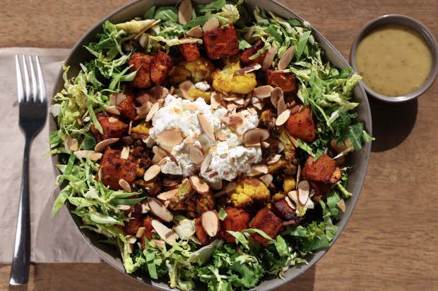 Kale and Brussels sprouts are enriched with roasted butternut squash and cauliflower, goat cheese and toasted almonds. (Hayne Palmour IV / For The San Diego Union-Tribune)