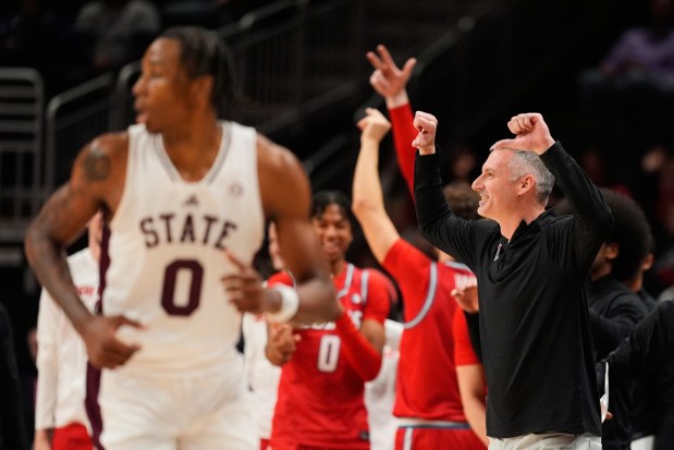 New Mexico head coach Eric Olen celebrates a basket during the second half of an NCAA college basketball game against Mississippi State, Friday, Nov. 21, 2025, in Kansas City, Mo. (AP Photo/Charlie Riedel)