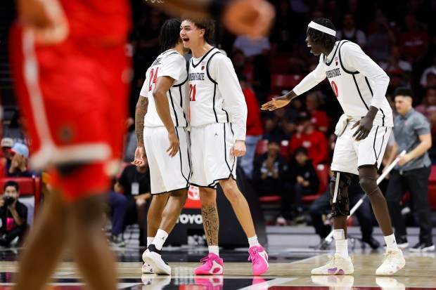 Taj Degourville #24, Miles Byrd #21, and Magoon Gwath #0 of San Diego State celebrate during their game against New Mexico at Viejas Arena on Saturday, Jan. 17, 2026 in San Diego, California. (Meg McLaughlin / The San Diego Union-Tribune)