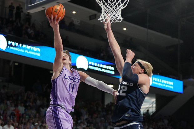 Grand Canyon guard Caleb Shaw drives on Utah State forward Karson Templin (22) during the second half of an NCAA college basketball game, Saturday, Jan. 17, 2026, in Phoenix. (AP Photo/Rick Scuteri)