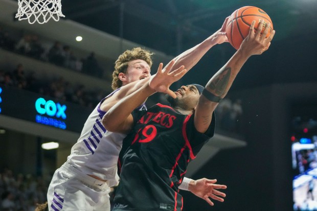 Grand Canyon's Caleb Shaw blocks a shot by San Diego State's Reese Dixon-Waters during the first half of Wednesday's game at GCU Arena in Phoenix, Ariz.(Darryl Webb, for The San Diego Union-Tribune)