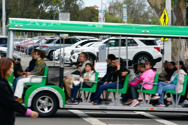 Several signs posted to notify park visitors that effective January 5th, 2026, "Paid Parking within Balboa Park Begins."   (Nelvin C. Cepeda / The San Diego Union-Tribune)