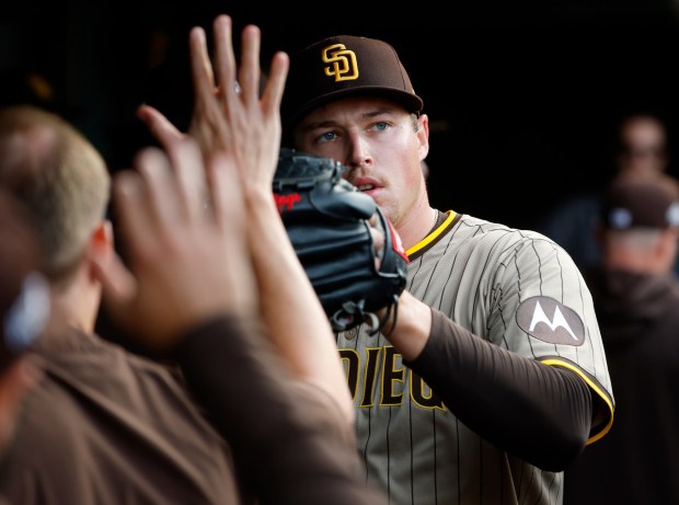 Mason Miller #22 of the San Diego Padres greets teammates after being pulled in the eighth inning against the Chicago Cubs during Game 2 of the NL Wild Card Series at Wrigley Field on Oct. 1, 2025 in Chicago, Illinois. (Photo by K.C. Alfred / The San Diego Union-Tribune)
