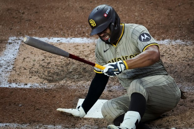 Xander Bogaerts #2 of the San Diego Padres winces after falling while batting against the Chicago Cubs during Game 3 of the NL Wild Card Series at Wrigley Field on Thursday, Oct. 2, 2025 in Chicago, Illinois. (Meg McLaughlin / The San Diego Union-Tribune)