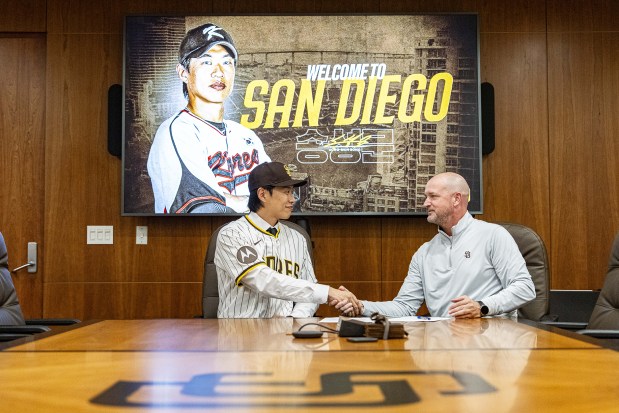Former KBO player Sung-Mun Song shakes hands with Padres vice president of amateur and international scouting Pete DeYoung after signing a contract with the San Diego Padres at Petco Park on Saturday. (Photo by Armond Feffer/San Diego Padres)