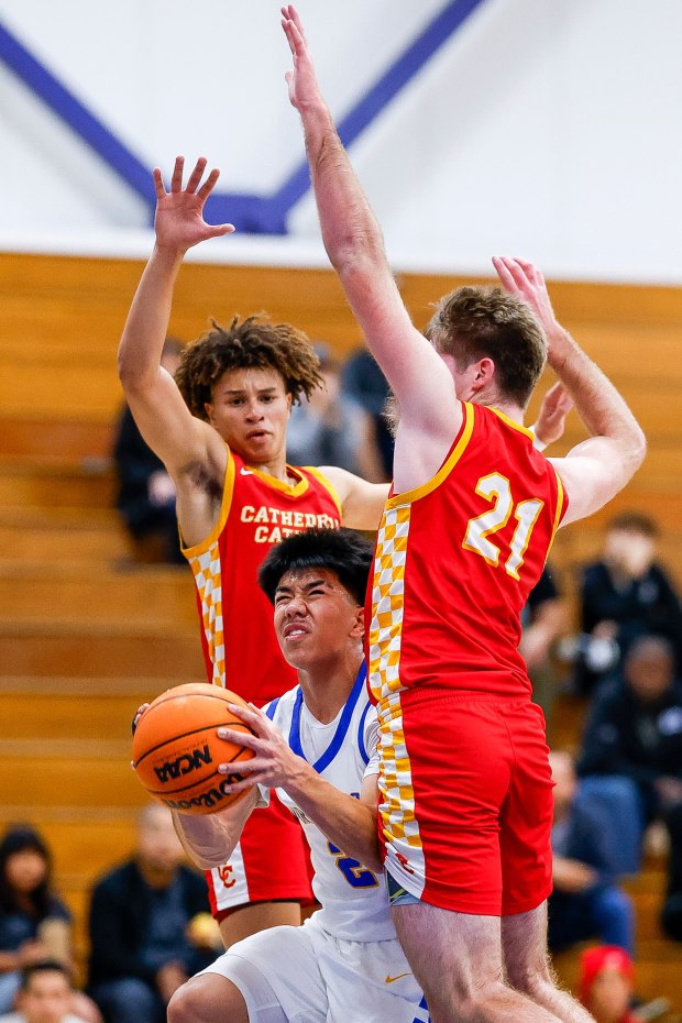 Mira Mesa's Che Lesperance #2 attempts a shot against Cathedral Catholic's Seimir Roberson #3 and Kevin Clark #21 during their game at Mira Mesa High School on Tuesday, Jan. 20, 2026 in San Diego, California. (Meg McLaughlin / The San Diego Union-Tribune)