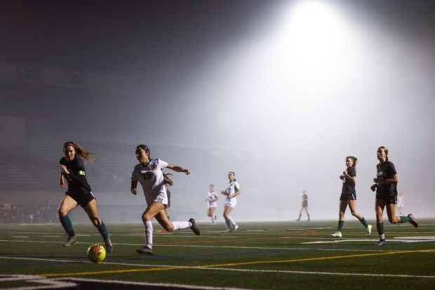 Coroando's Kalista Searles and Patrick Henry's Aleda Urbina run for the ball during their match at Coronado High School on Thursday, Jan. 15, 2026 in Coronado, California. (Meg McLaughlin / The San Diego Union-Tribune)