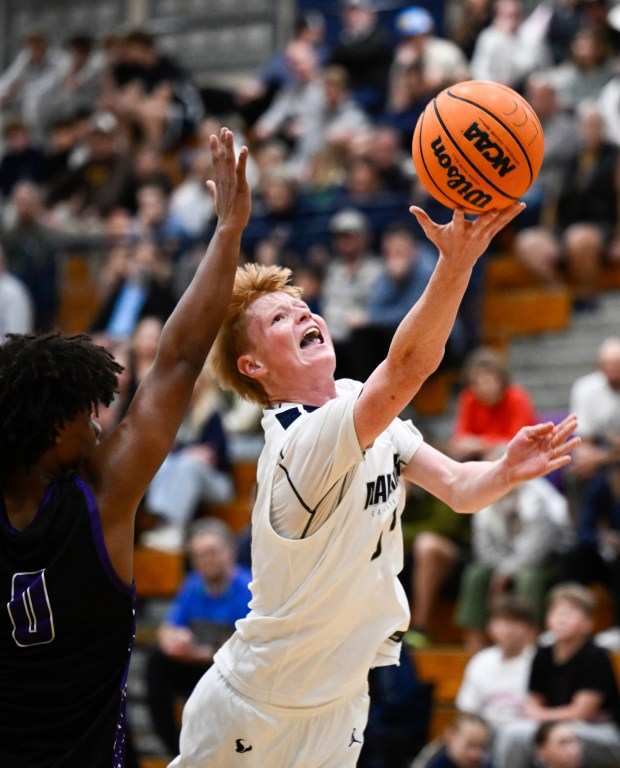 La Costa Canyon's Wyatt Brown (33) shoots past the block of Carlsbad's Dylan Sims (0) during the first half Jan. 16, 2026 in Carlsbad, Calif. (Photo by Denis Poroy)