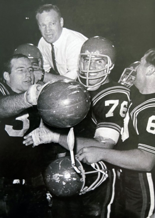 Steve Duich (76) and his Aztecs teammates carry coach Don Coryell off field after capping 11-0 season in 1966.