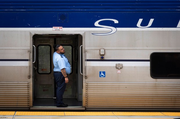 An employee checks out the door of a Pacific Surfliner train on Wednesday, Jan. 21, 2026 in Oceanside, California. (Meg McLaughlin / The San Diego Union-Tribune)