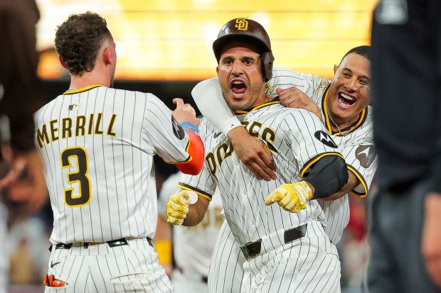 Manny Machado #13 and Ramon Laureano #5 of the San Diego Padres celebrate after Laureano hit a walk-off single against the Boston Red Sox during the tenth inning at Petco Park on Saturday, Aug. 9, 2025 in San Diego, CA. (Meg McLaughlin / The San Diego Union-Tribune)