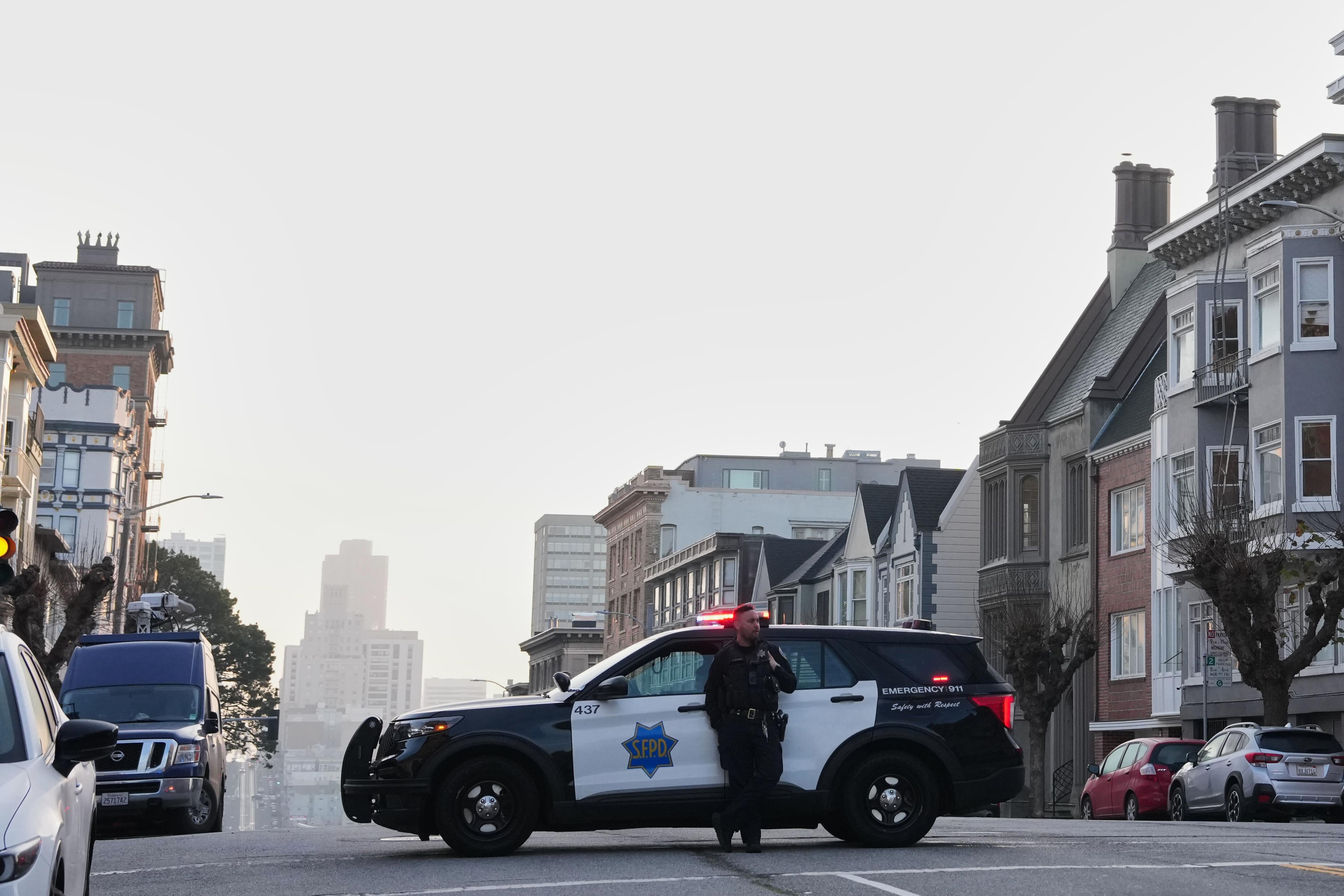 Police block a street during a search for a mountain...