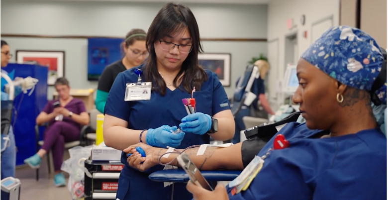 San Diego Blood Bank employees help donate blood.