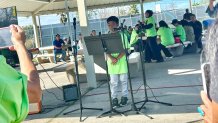Lazarus Millette, 9, (center) sings Saturday during a memorial service for his missing mother, Chula Vista, Calif., January 17, 2026.