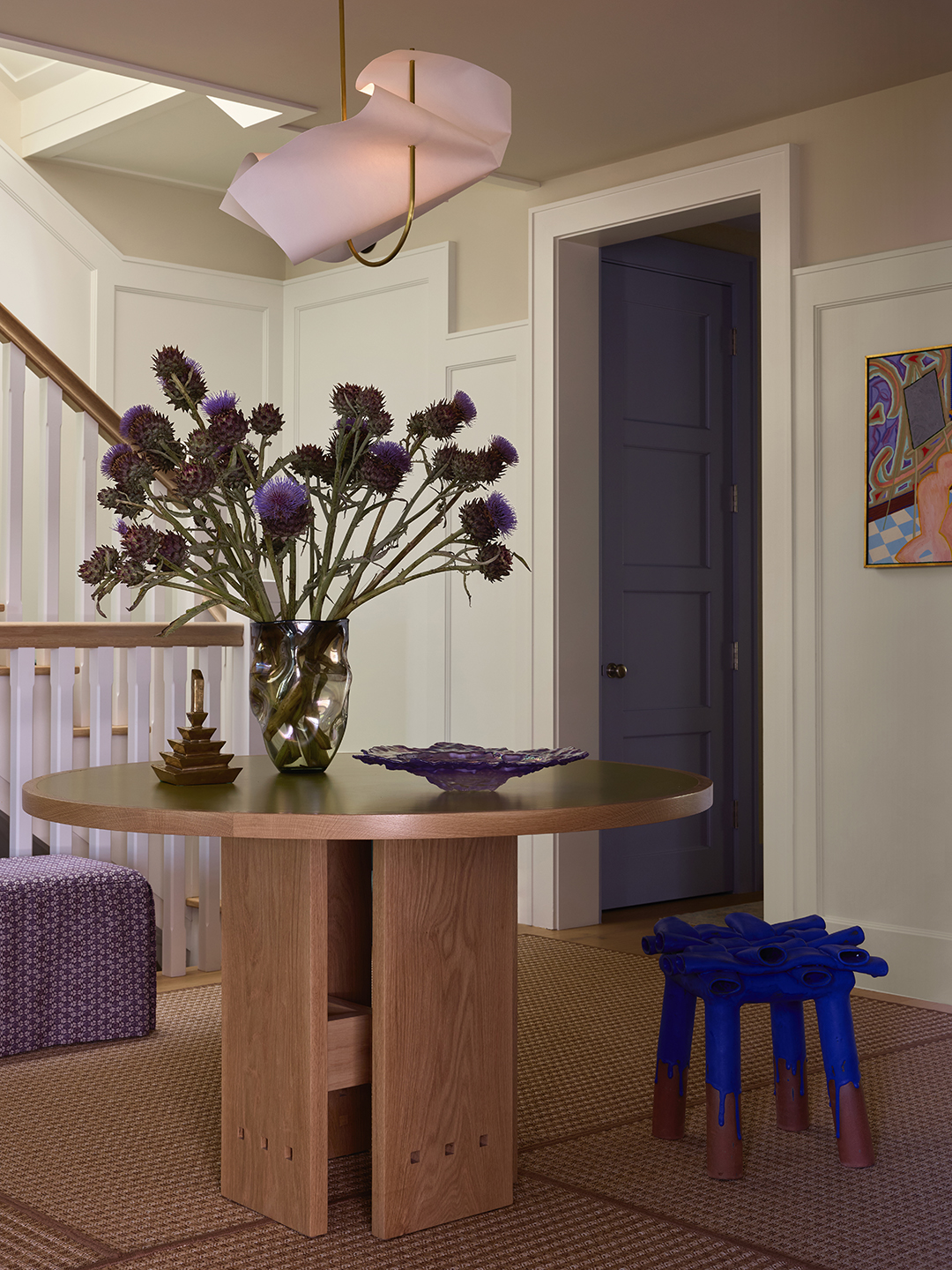 entryway with wood table and flowers