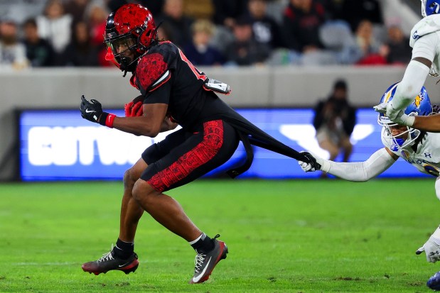 Donovan Brown #14 of San Diego State has his jersey pulled by Caleb Presley #0 of San Jose State during their game at Snapdragon Stadium on Saturday, Nov. 22, 2025 in San Diego, California. (Meg McLaughlin / The San Diego Union-Tribune)