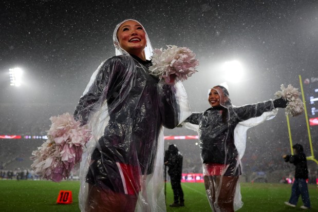San Diego State dance team member Audrey Kim performs in the rain during the Aztecs' game against the Boise State Broncos at Snapdragon Stadium on Saturday, Nov. 15, 2025 in San Diego, California. (Meg McLaughlin / The San Diego Union-Tribune)