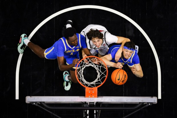 Xavier Booker #1 and Jamar Brown #4 of UCLA and Miles Heide #40 of San Diego State vie for the rebound during an exhibition game at Viejas Arena on Friday, Oct. 17, 2025 in San Diego, California. (Meg McLaughlin / The San Diego Union-Tribune)
