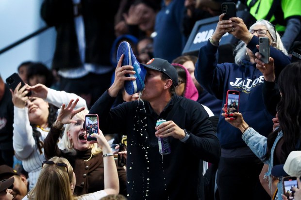 Fans take turns drinking beer out of a shoe during the Padres game against the Tampa Bay Rays at Petco Park on Saturday, April 26, 2025 in San Diego, CA. (Meg McLaughlin / The San Diego Union-Tribune)