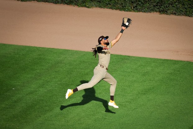 Fernando Tatis Jr. #23 of the San Diego Padres makes a catch in the outfield during the eighth inning against the Chicago Cubs during game two of the NL Wild Card Series at Wrigley Field on Wednesday, Oct. 1, 2025 in Chicago, Illinois. (Meg McLaughlin / The San Diego Union-Tribune)