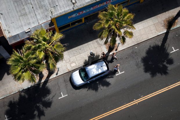 San Diego, CA - August 21: A group of people get into their car, parked along Garnet Avenue in Pacific Beach on Thursday, Aug. 21, 2025 in San Diego, CA. The city of San Diego's parking rate increases are to start Sunday in Pacific Beach.