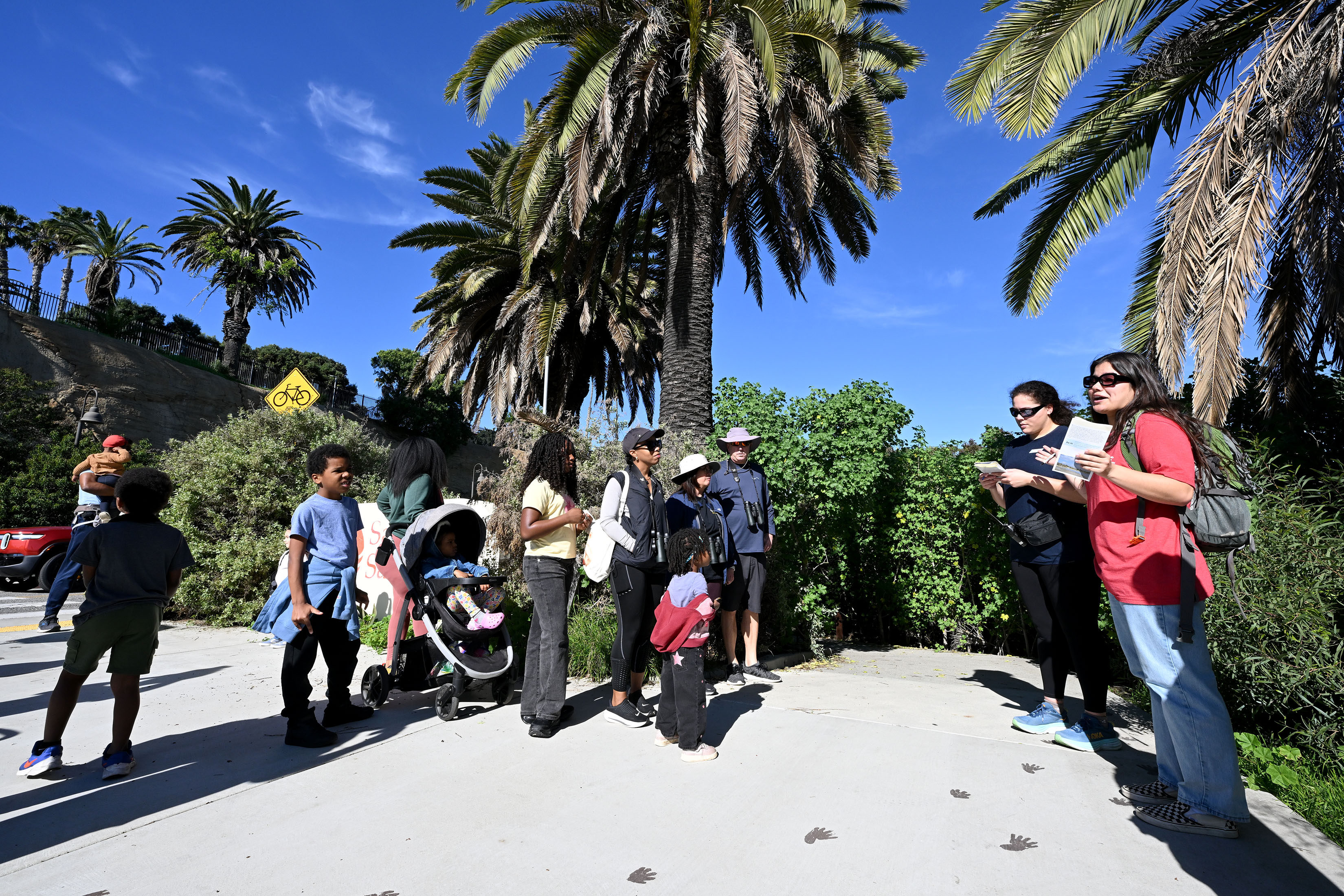 Aquarium educators Lani Brand and Rachel Ichimaru guide participants on...