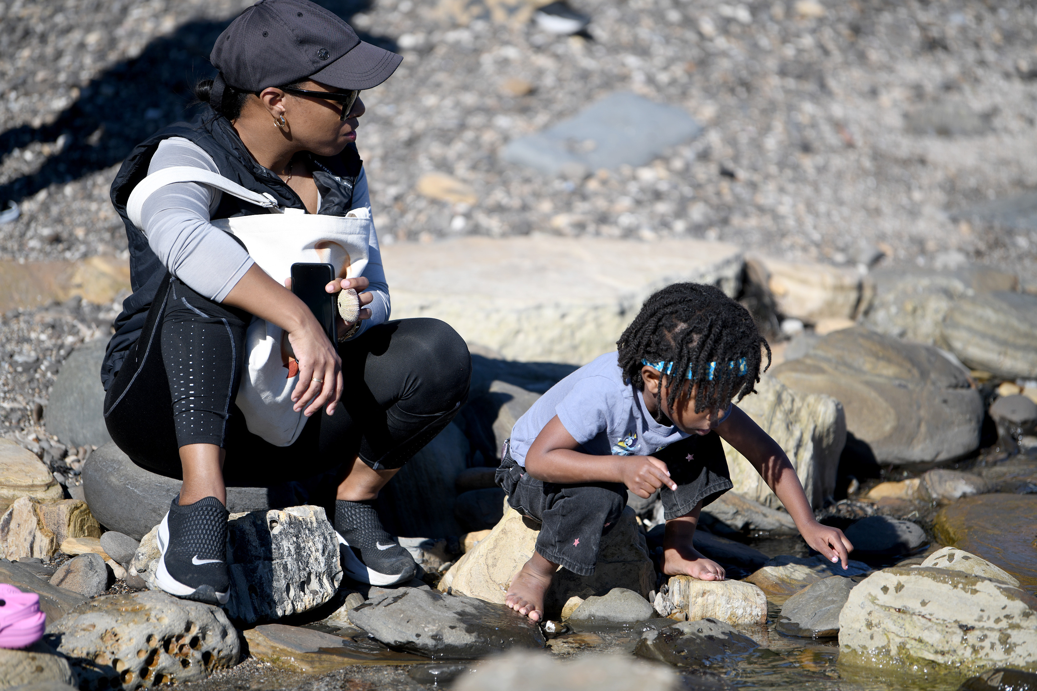 Tara Gomez and Pria Hampton, 3, enjoy the tide-pools during...