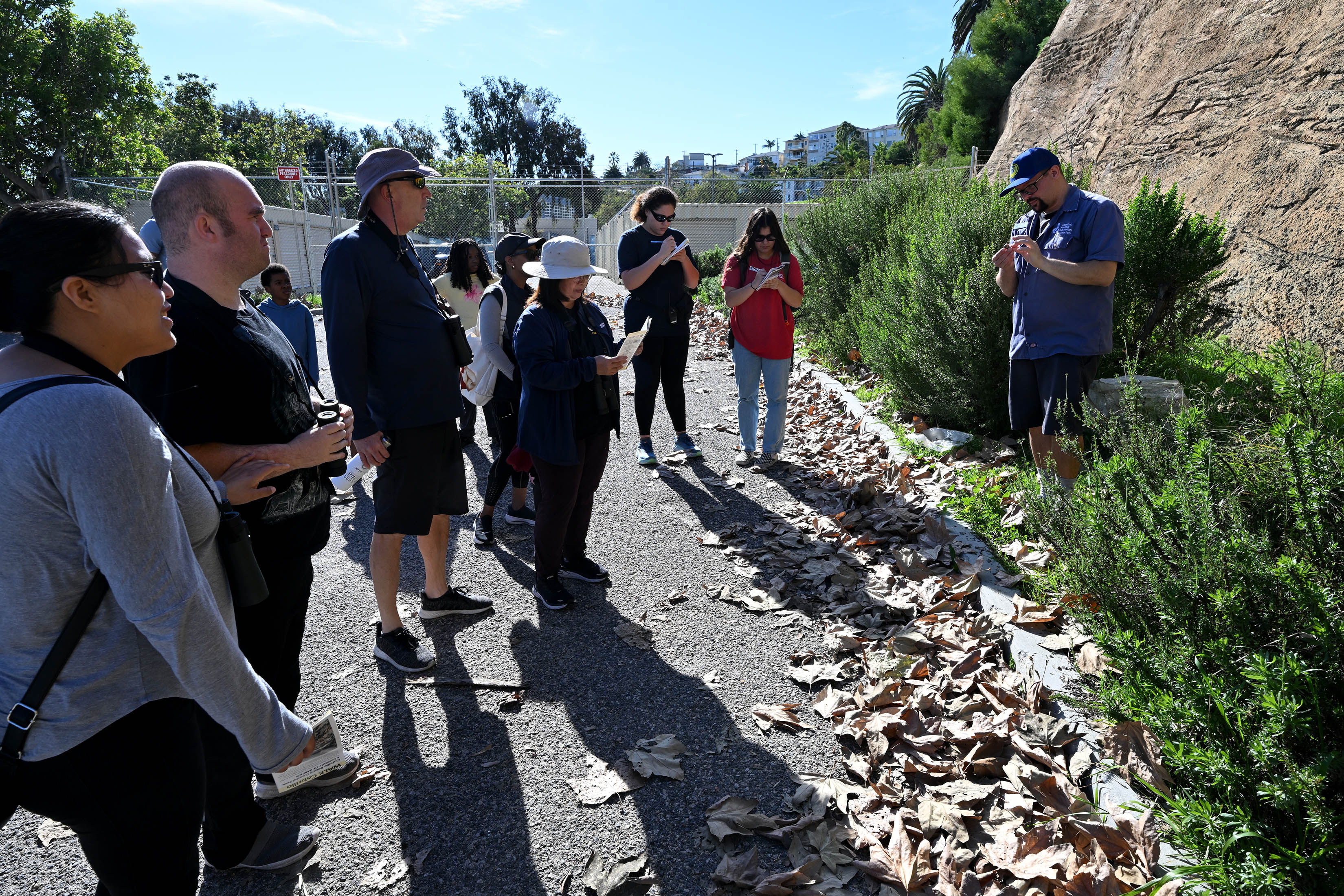 Bayne Westrick-Snapp, an squarium educator, helps guide participants on a...