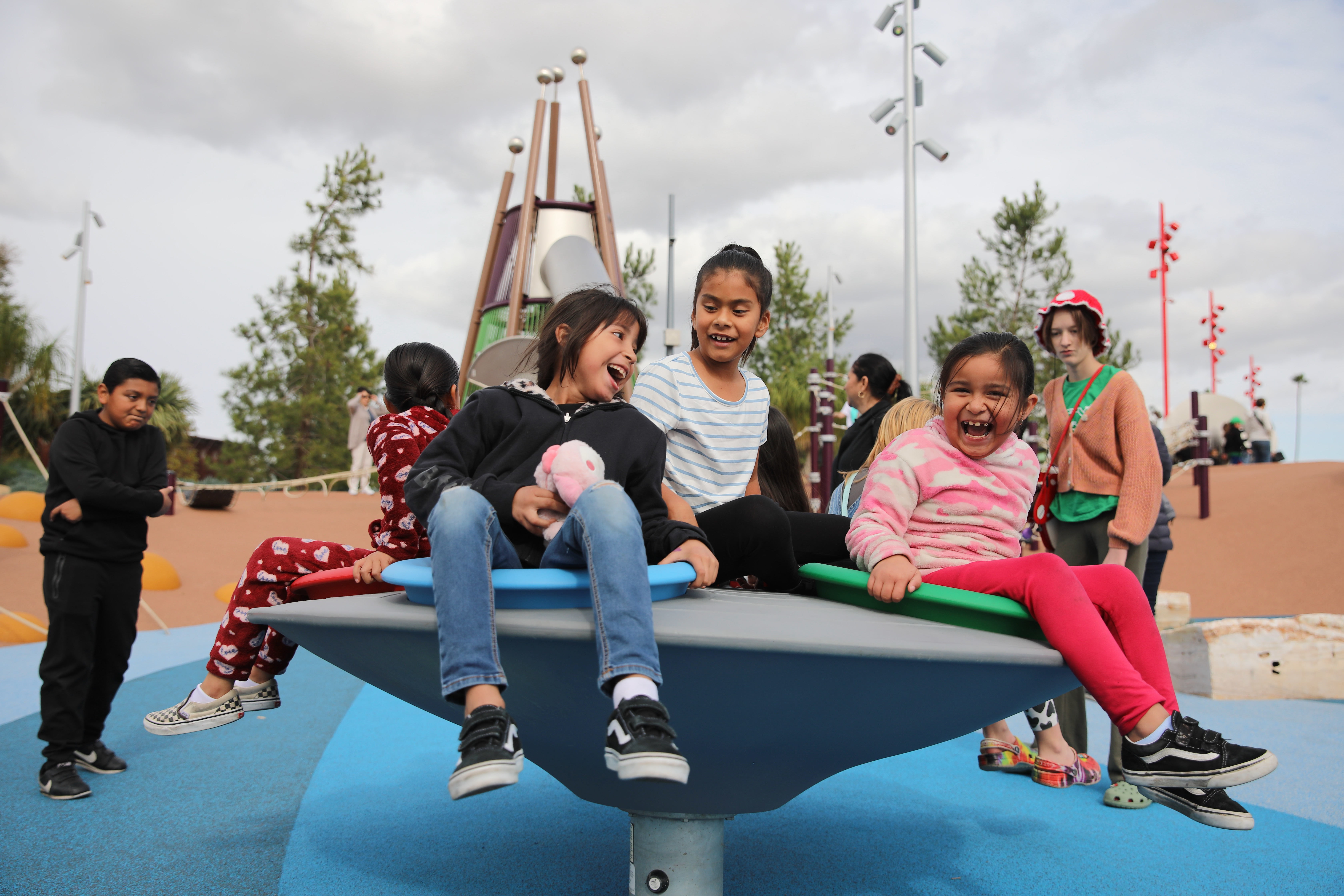 Children spin around in a play area at the Wilmington...