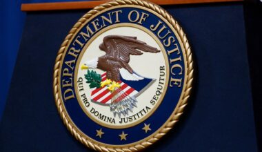 The seal of the U.S. Justice Department is seen on the podium in the Department's headquarters briefing room in Washington, January 24, 2023. (Reuters/Kevin Lamarque/File Photo)