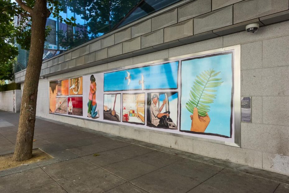 A mural on a gray stone wall depicts various scenes including a woman kneeling, a driver, a hand holding a leaf, and birds flying, on a city sidewalk beside a tree.