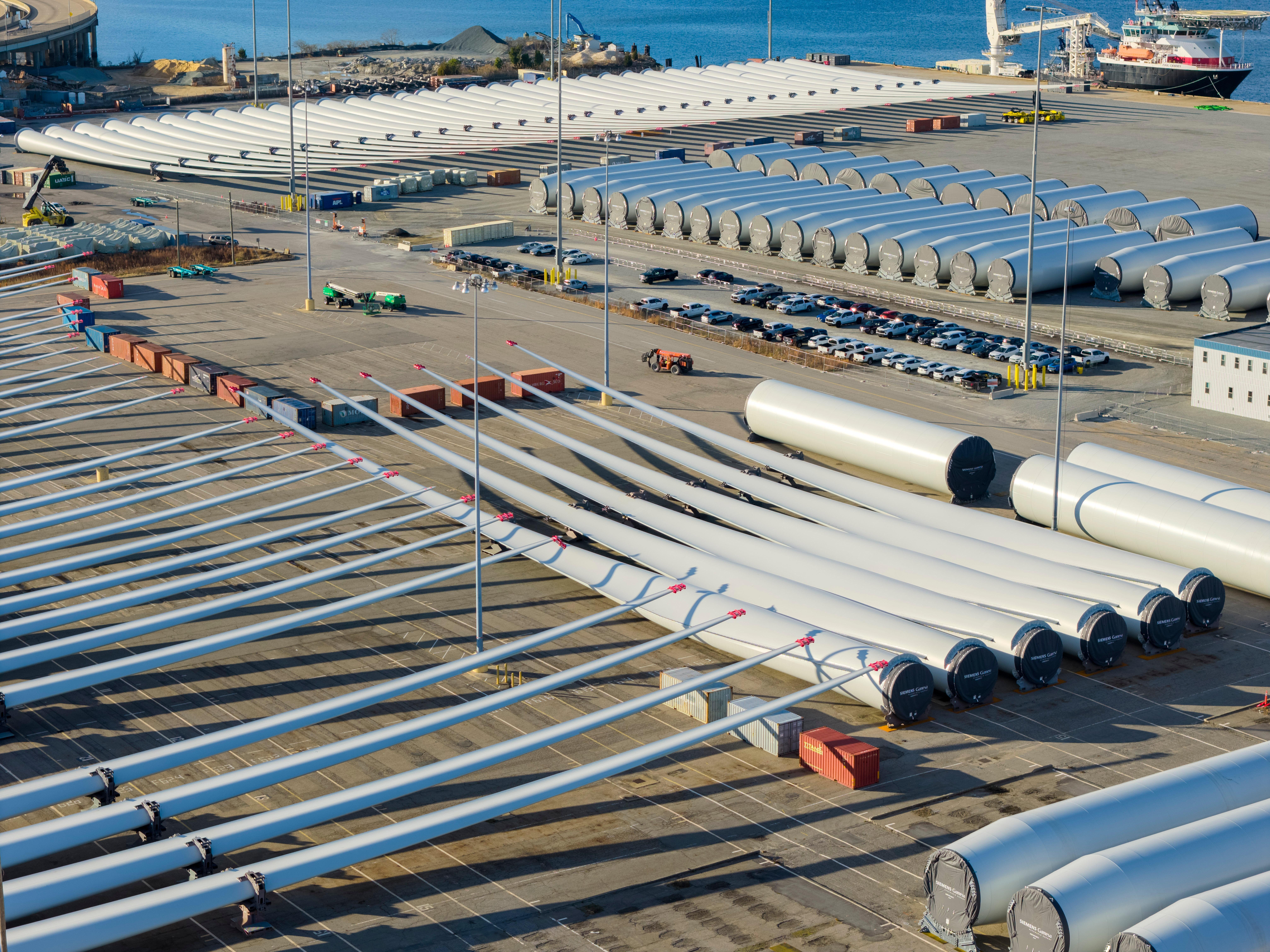 FILE – Wind turbine bases, generators and blades sit at...
