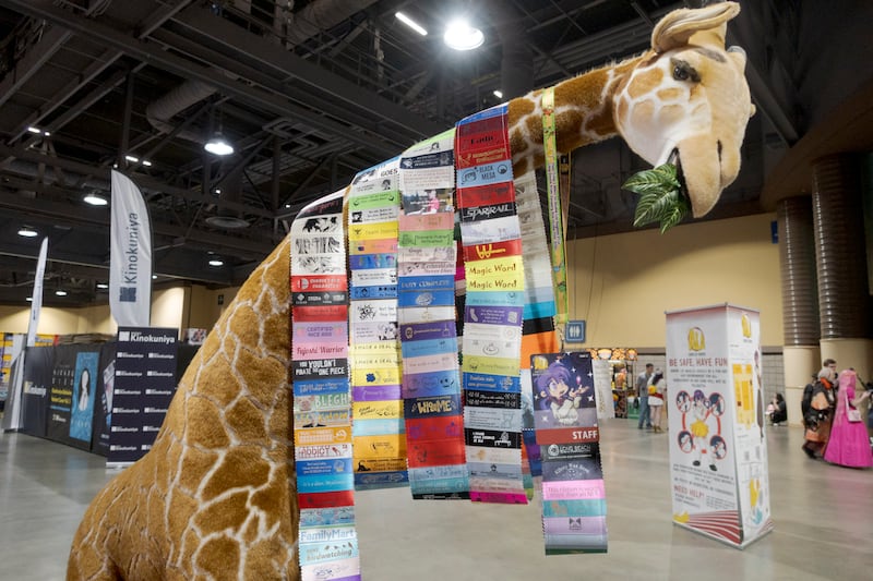 Giraffe with ribbons around its neck