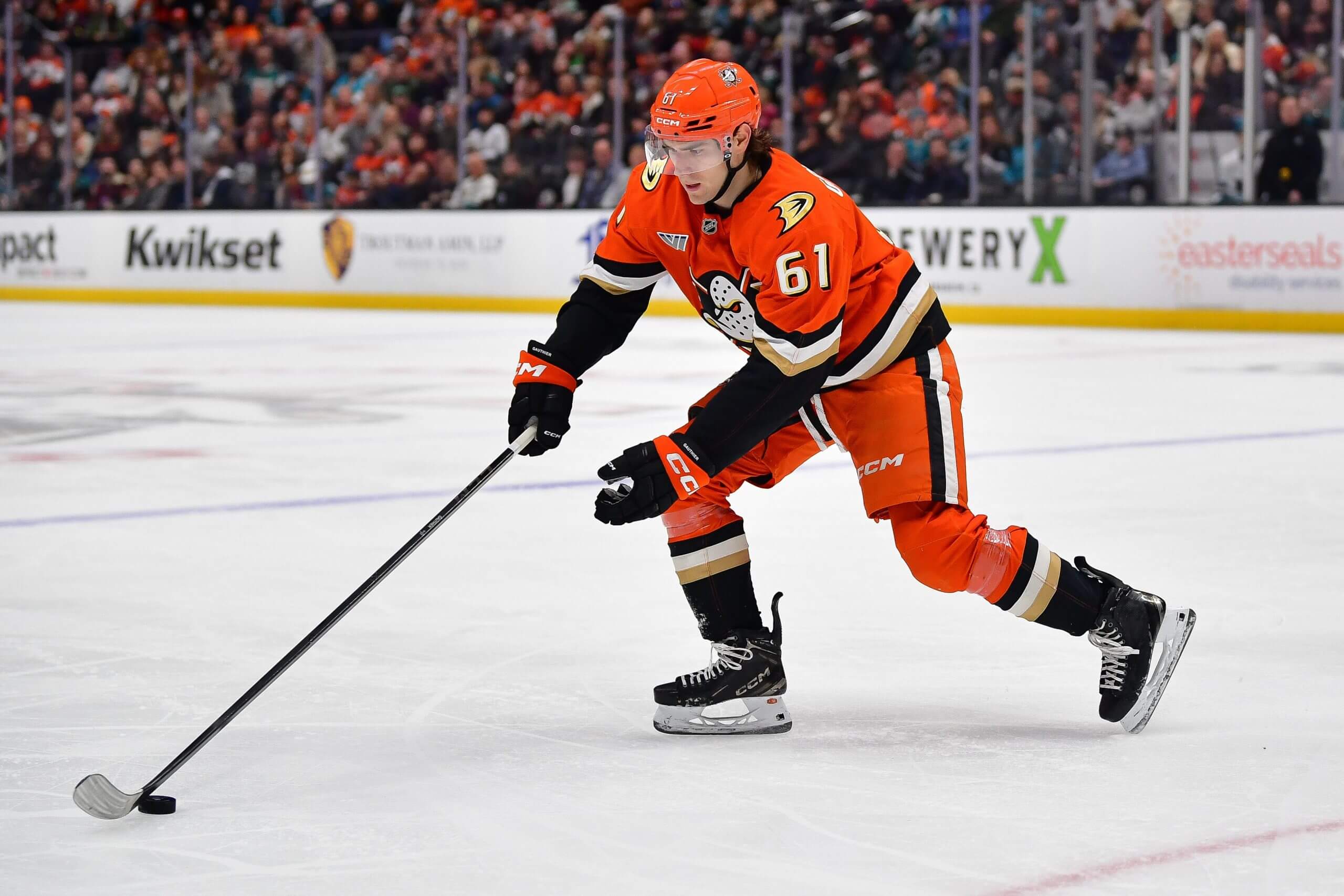 Cutter Gauthier skates with the puck during a Ducks game.