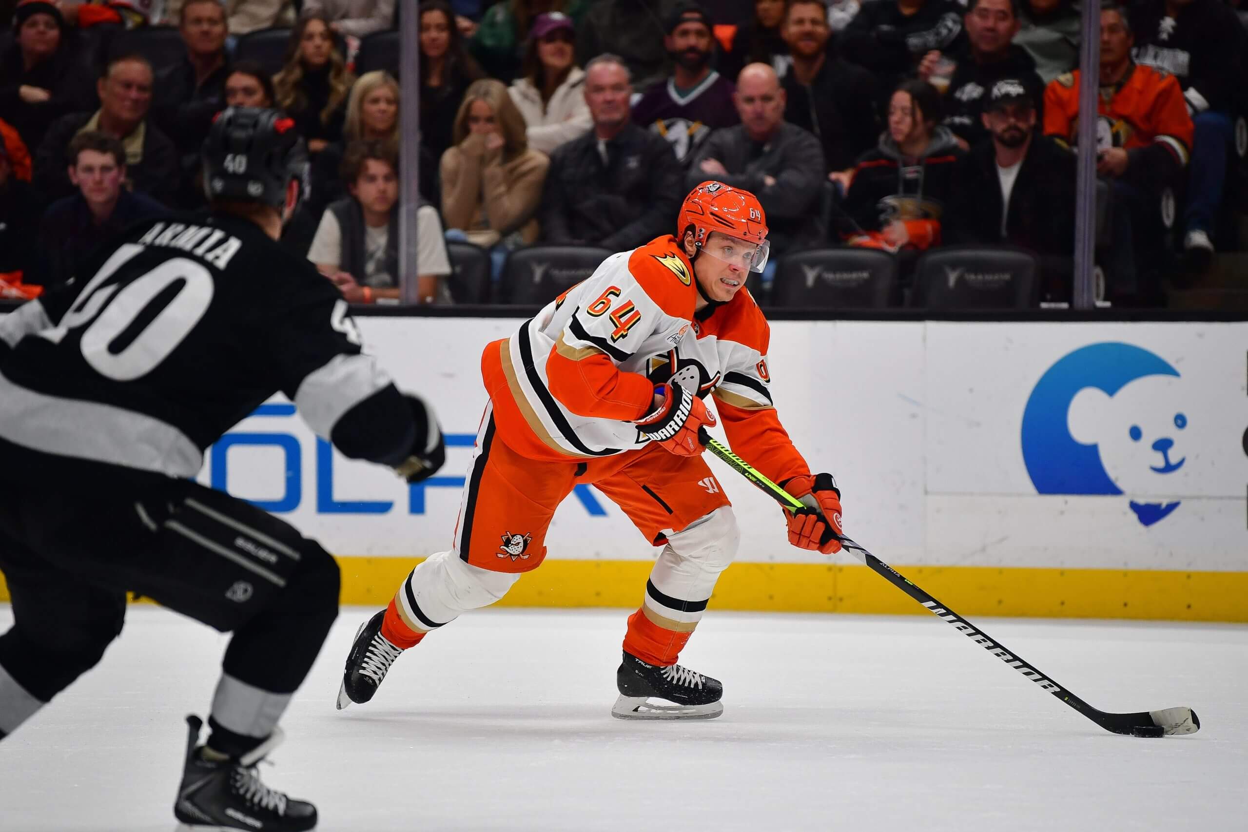 The Ducks' Mikael Granlund skates with the puck, with the Kings' Joel Armia defending in the foreground.