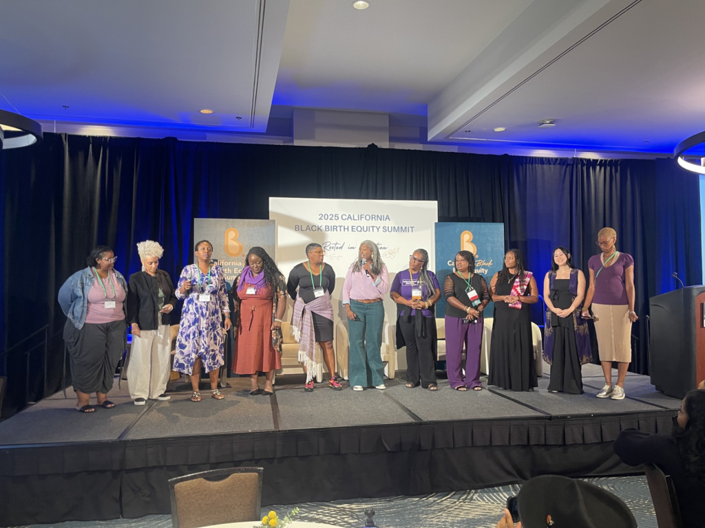 Organizers and participants of the 2025 California Black Birth Equity Summit close out the event with an uplifting a cappella performance.