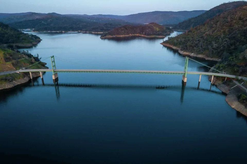 The Bidwell Bar Bridge at Lake Oroville which is filled to 100% capacity and discharging water to allow for incoming snowmelt from the Feather River in Oroville, Calif., on Thursday, April 13, 2023. Historic snowfall in parts of California have left the state with more water than it's used to, recharging aquifers, overflowing streams and resuscitating areas once bereft of water. (Carlos Avila Gonzalez/S.F. Chronicle)
