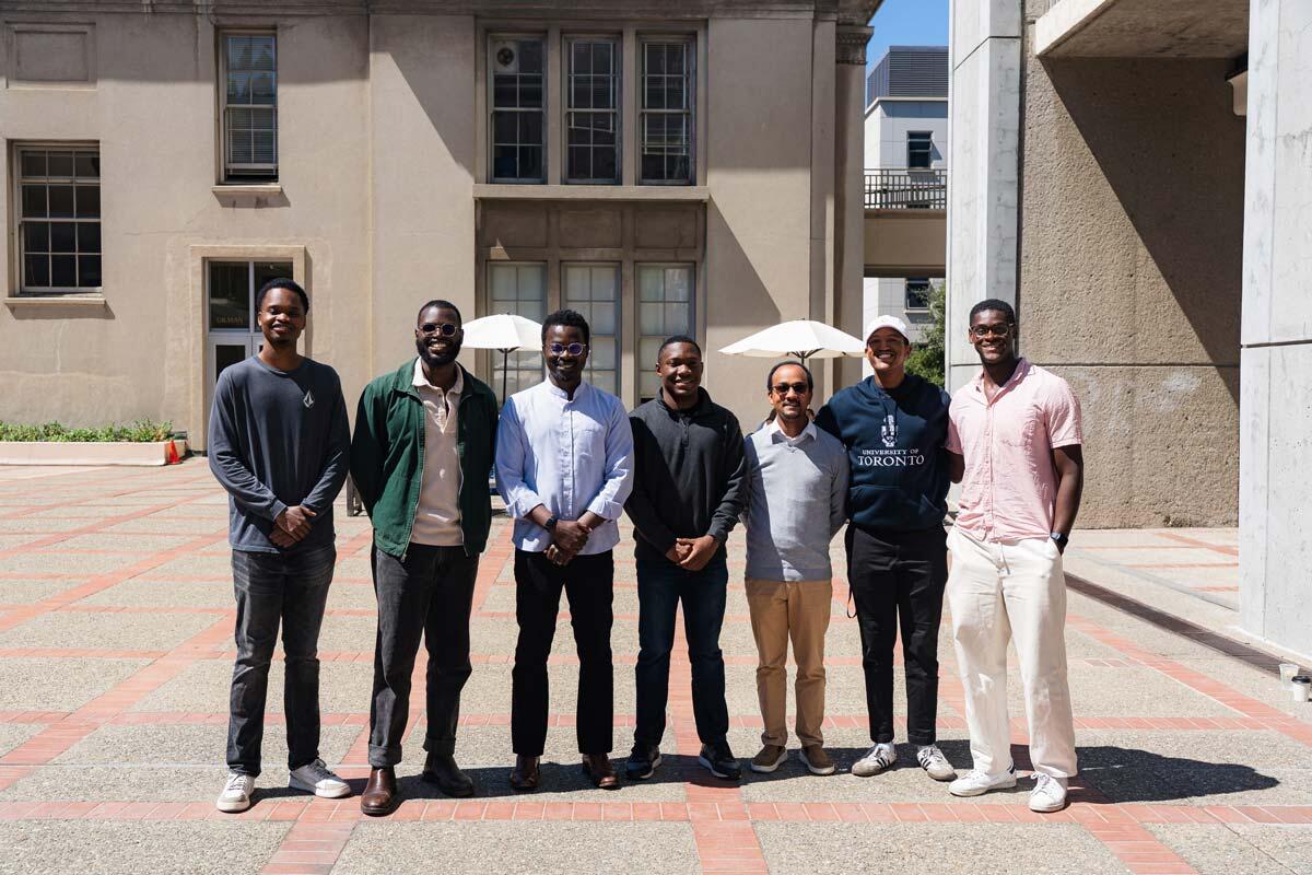 Seven men posing for a photo on the UC Berkeley College of Chemistry plaza