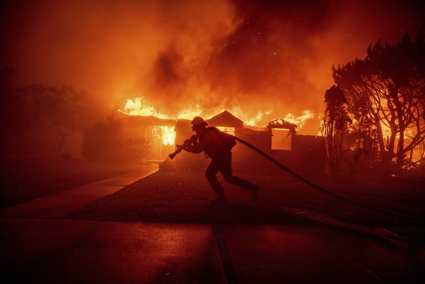 A firefighter battles the Palisades Fire on January 7, 2025