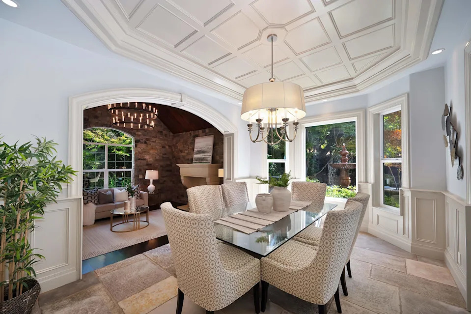 Vaulted beamed ceilings and reclaimed hardwoods set an inviting tone in the elegant, open living areas.