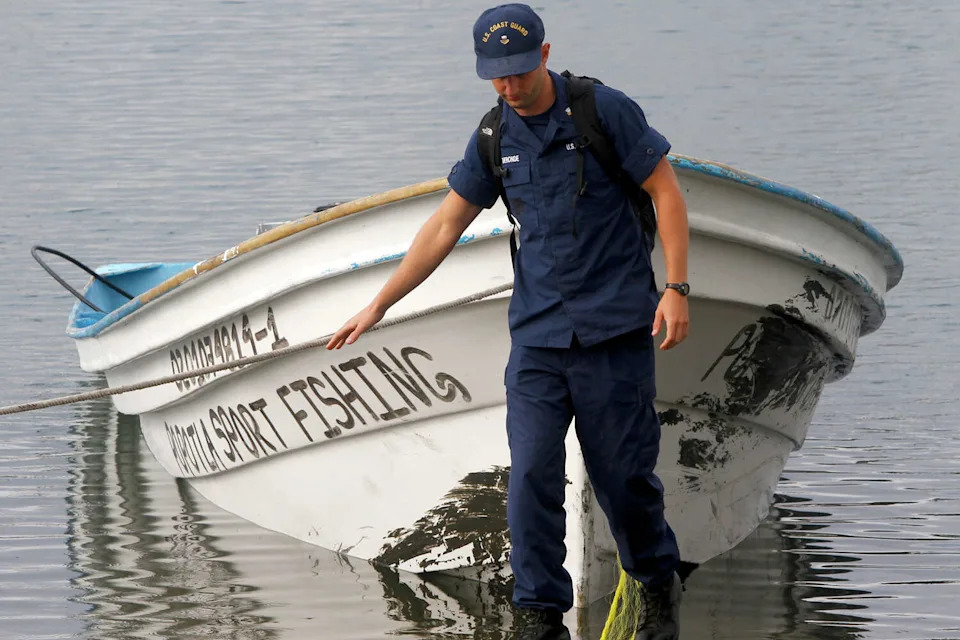 FILE: Law enforcement officials gather on the boat ramp in Marina Del Rey, Calif., where a panga boat is tethered. (Mark Boster/LA Times via Getty )