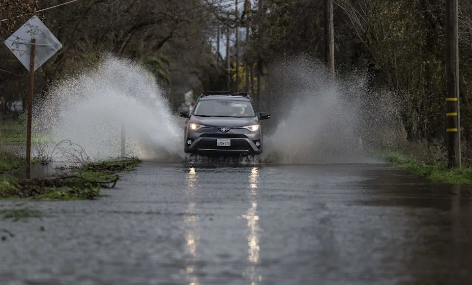 A motorist drives on the flooded Cherry Lane in Rio Linda on Friday, Dec. 26, 2025. Heavy rains on Christmas day brought flooding to the area from nearby Dry Creek.