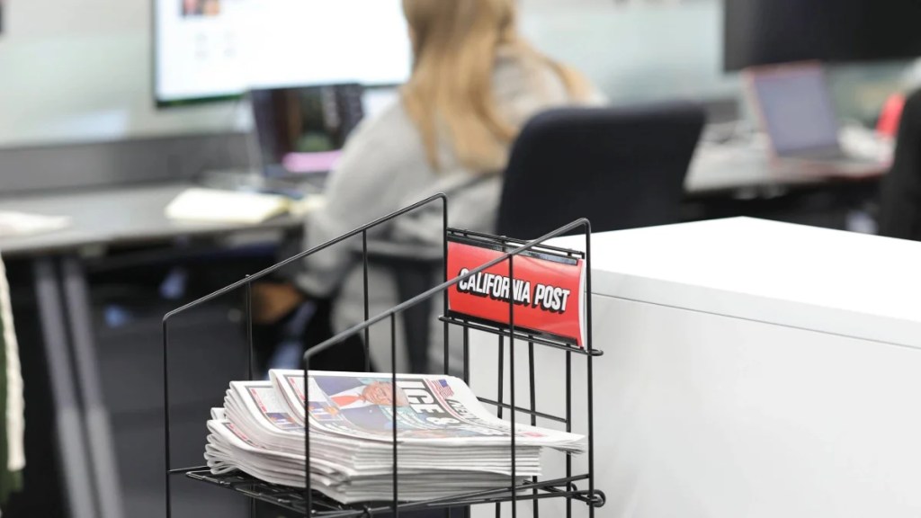 Dummy copies of the paper are scattered throughout the Post's newsroom